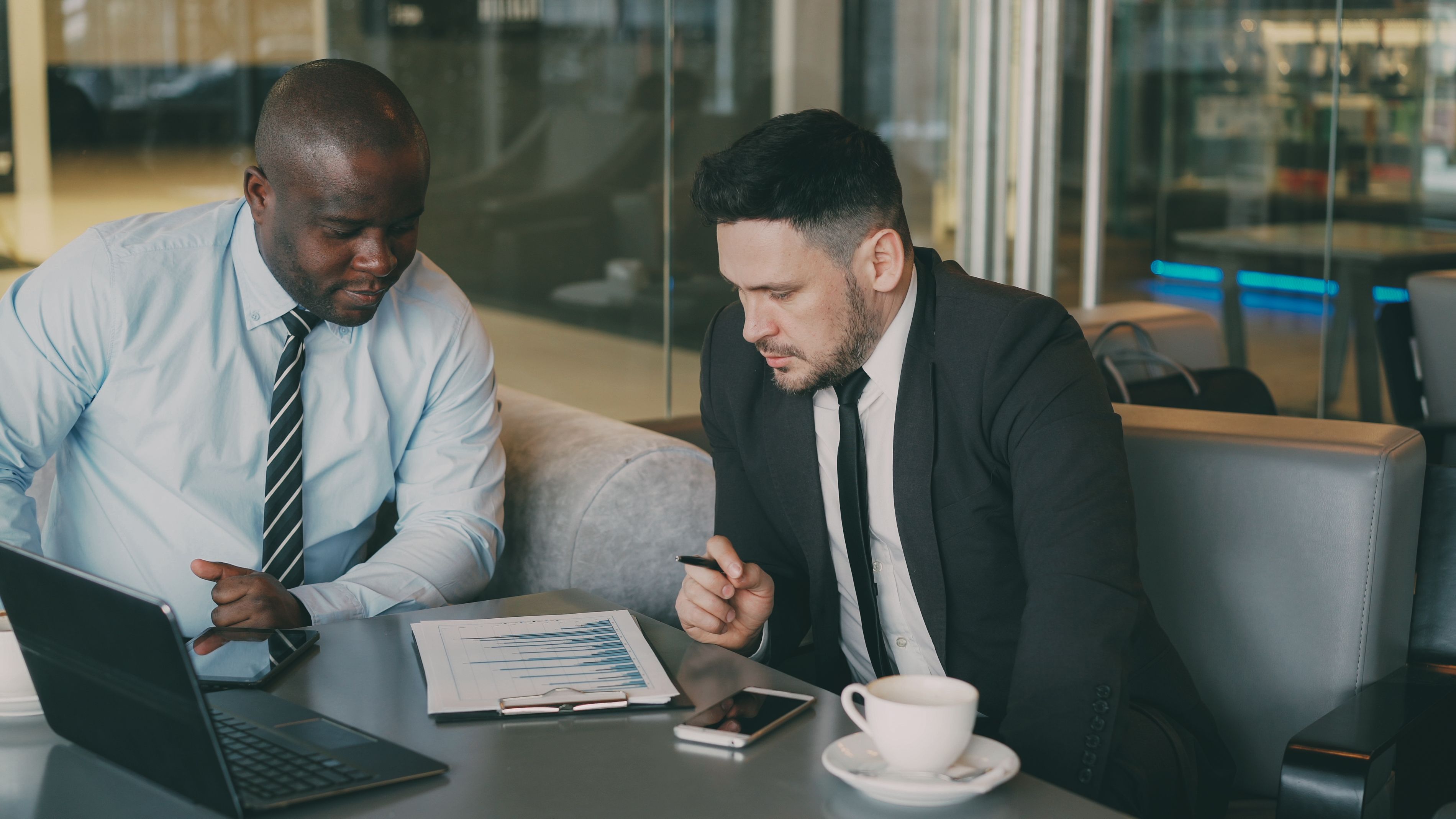 Two colleagues reviewing a financial chart in a meeting